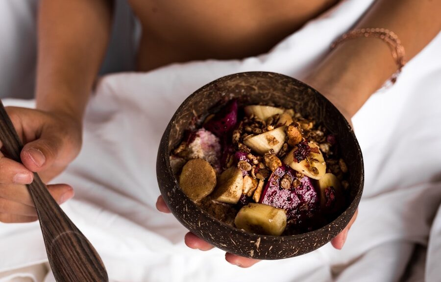 sliced fruits on coconut shell bowl on woman's hand in bed