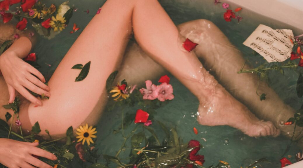 bathtub with water and flowers